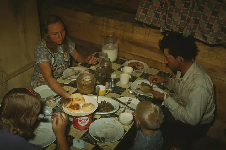 A family eating dinner in their dugout home